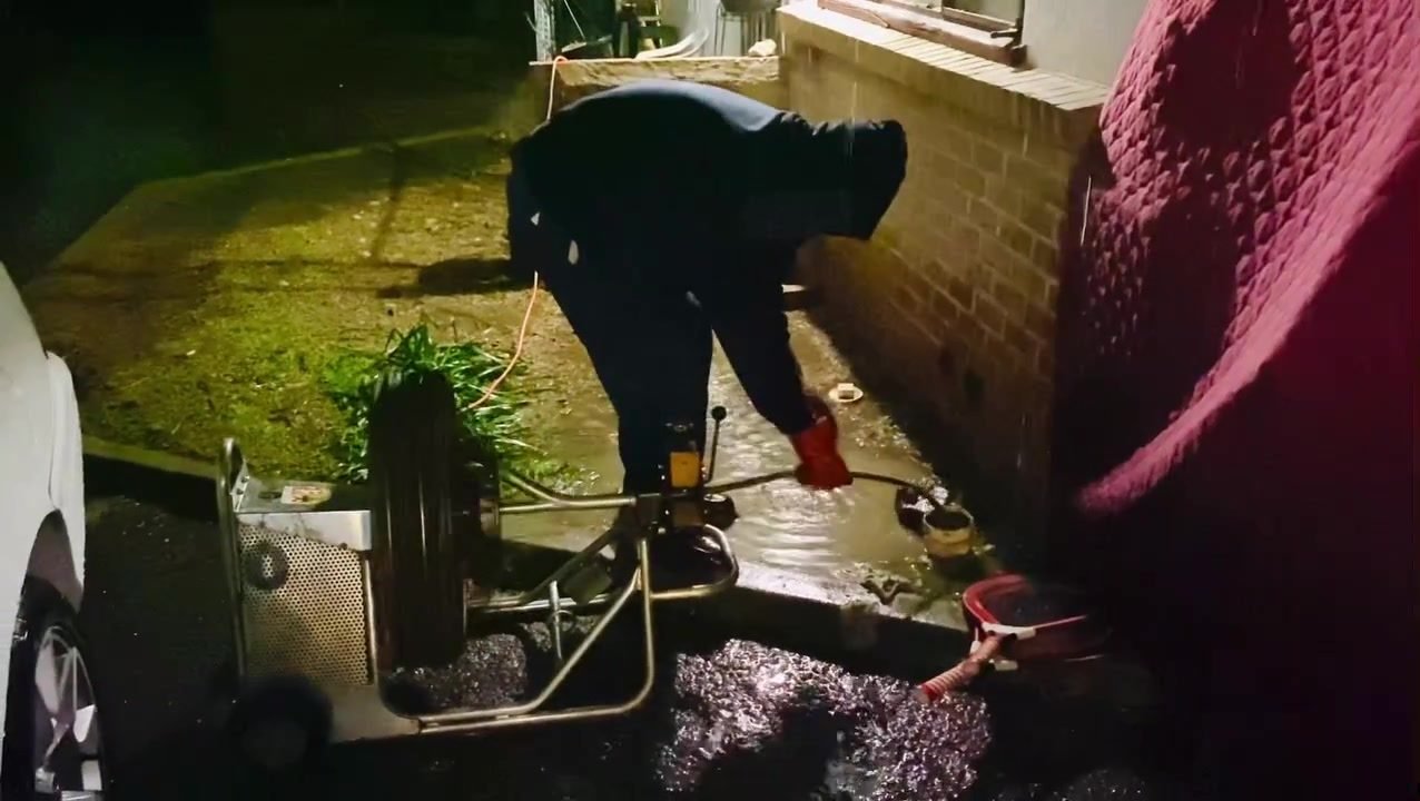 Costless Plumbing crew on a night emergency drain job in Fresno