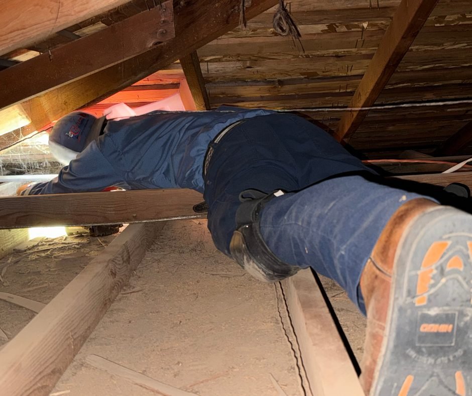 Technician working in attic
