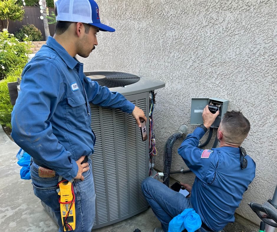 Costless Plumbing technicians servicing a residential air conditioning system in Fresno