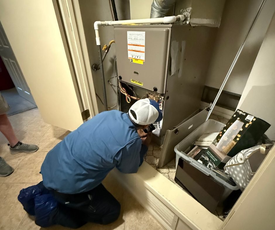 Technician diagnosing a furnace in a Fresno home