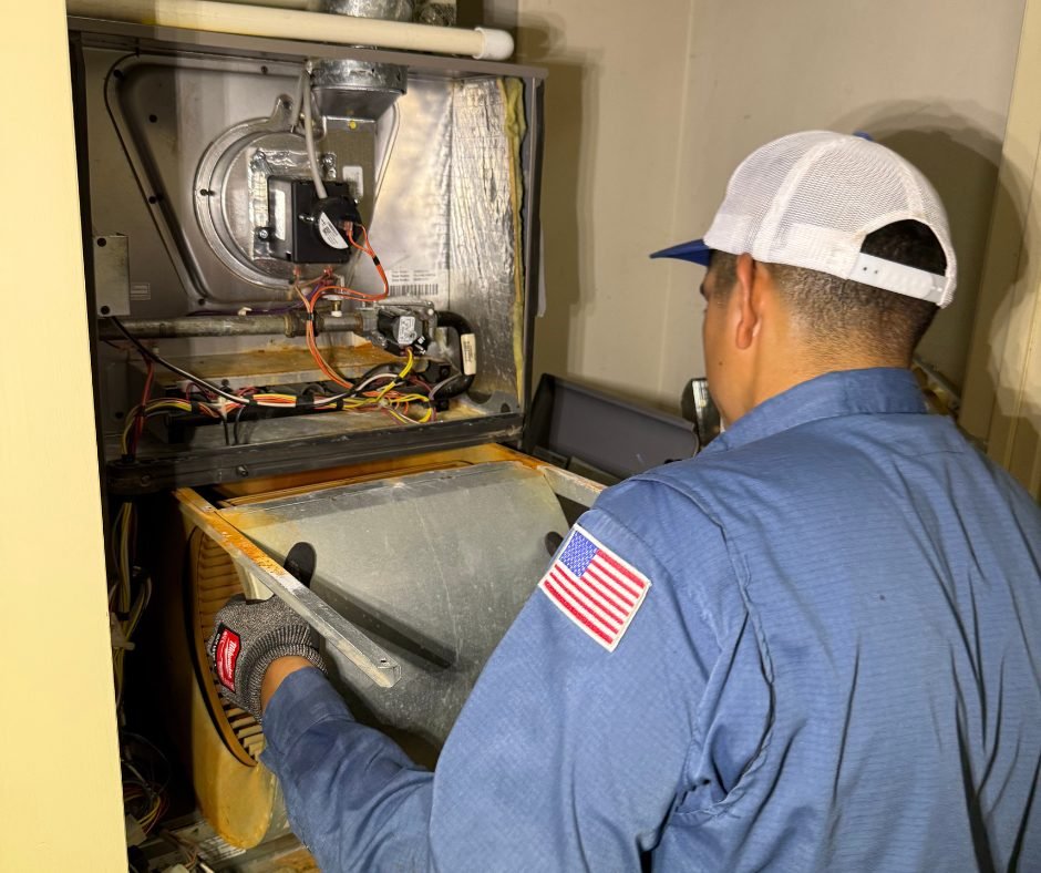 Technician servicing a furnace